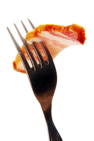 a thin slice of ham slice on a metal fork, photo on the white background 