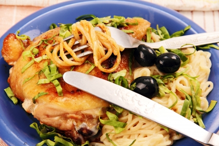 on the blue portion of the plate of fried chicken, noodles, olives and parsley の写真素材