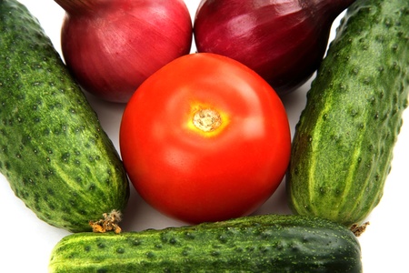 a few green cucumber, red tomato and young onions on a white background.の写真素材