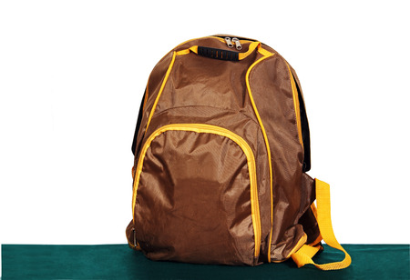 a small brown bag on a green surface, white .