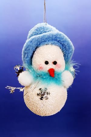 Christmas toy Christmas snowman photo on a blue .の写真素材