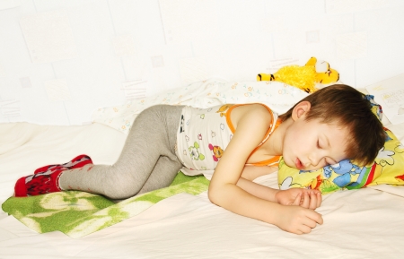 ittle baby asleep in bed, his head on the pillow close-up.の写真素材