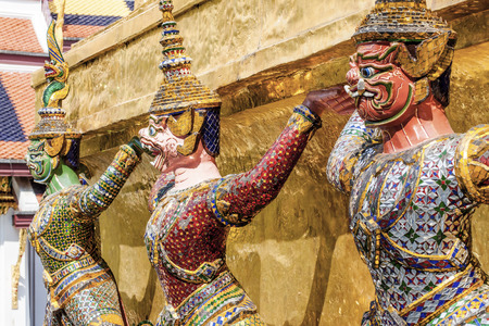 Golden Giant Guardian lifting up pagoda at Grand Palace Bangkok Thailandのeditorial素材
