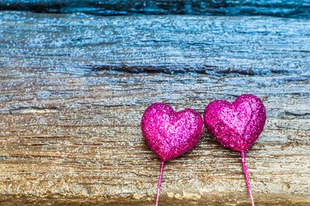 Sparkling pink hearts on gradient wooden backgroundの写真素材