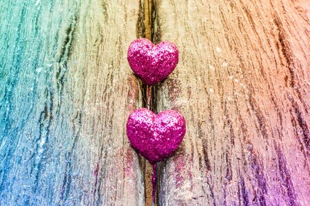 Sparkling pink hearts on gradient wooden backgroundの写真素材