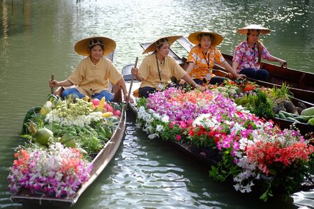 THAILAND - December 1, 2017: Unidentified women vendor fruits and flowers float in boats at RAMA IX Park, Bangkok, Thailand.のeditorial素材