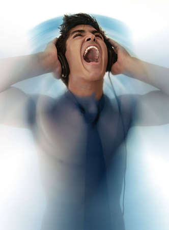young man with earphones screaming