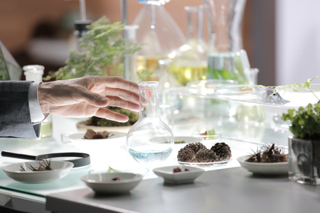 science's hand will grabing a jar in experimentの写真素材