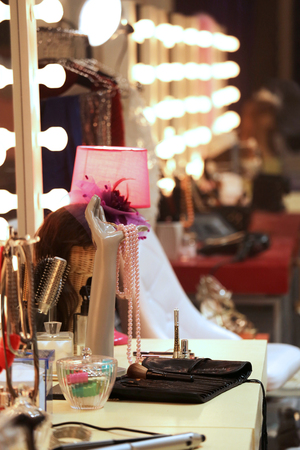 a lot of stuff on a make-up table in backstage of fashion showの写真素材