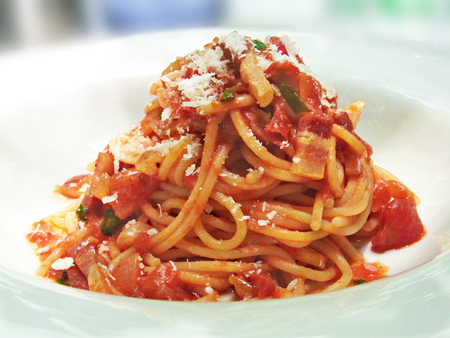 spaghetti fried with bacon and tomato sauce topping with parmesan cheeseの写真素材