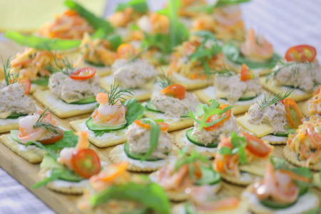 canape topping with tuna, shrimp, salmon and cheeseの写真素材