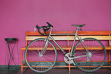 silver bicycle put on the chocking pink wallの写真素材