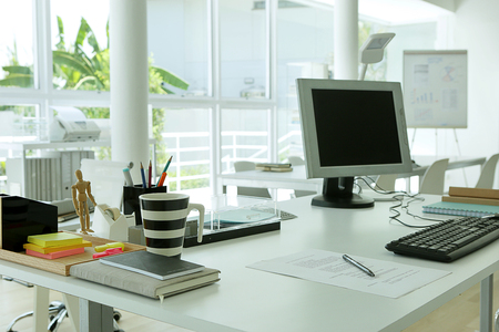a work paper ready on modern white desk station in modern loft officeの写真素材