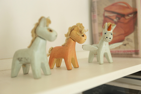 wooden horse and unicorn dolls put on the shelfの写真素材