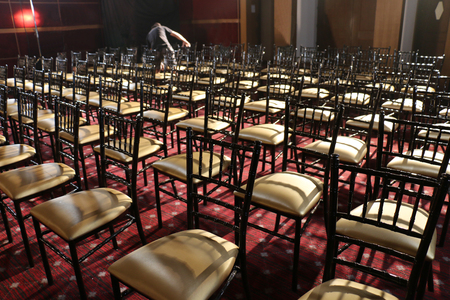 a lot of chairs put in a row in small auditorium for school playの写真素材