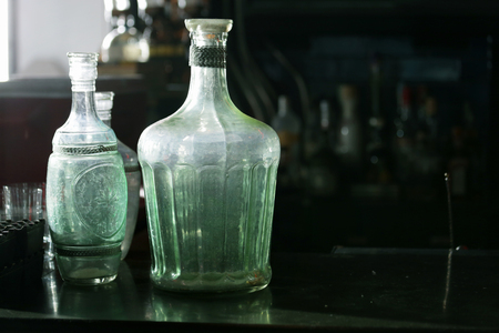 some vintage wine bottles for decorate on the counter bar in restaurant with black space for copyの写真素材