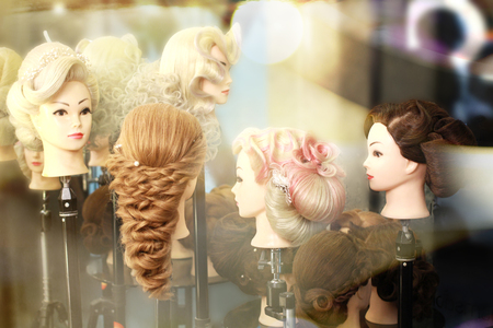 variety of hair styles on the head mannequin in salonの写真素材