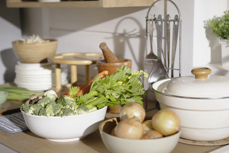 chop broccoli, celery, carrot and onion preparing for cooking in kitchenの写真素材