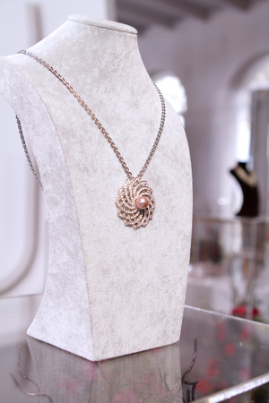 a fake pink gold pearl on diamond necklace in the jewelry store set used for shooting a movieの写真素材