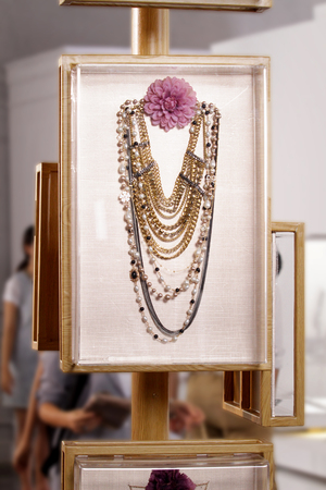 a fake gold chain and pearl necklace in jewelry store set used for shooting a movieの写真素材