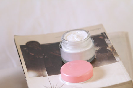 a jar of moisturizer cream open to show the beautiful swirl insideの写真素材