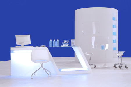 a beautiful reception counter in front of set of table and big round shelf in backgruondの写真素材