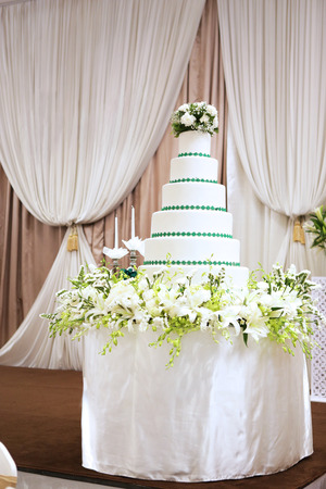 a big mock up layer cake used to be the base for real cake in wedding partyの写真素材
