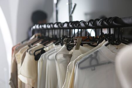 many clothes hanging on the black coat hangers