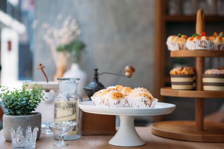 two difference cake stands and some bakeries put on counter bar in sidewalk coffee shopの写真素材