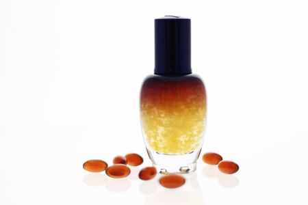 Cosmetic bottle put with some vitamin capsule on  whiteの写真素材