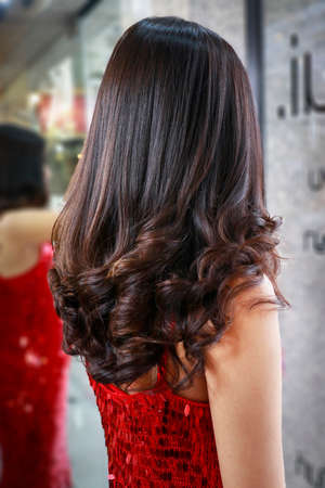beautiful dark hair are finally setting in salon ready for her partyの写真素材