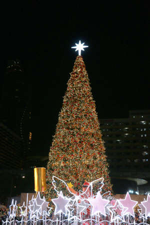 a christmas wreath decorated with a golden hear deer, white snowflakes and red balls put on a stand in hall wayの写真素材