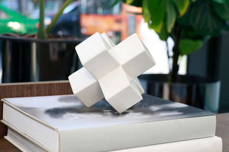 a white ceramic polygonal shape put on the book in livingroom for decorationの写真素材