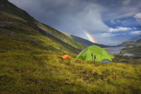 Camping in the nature. Campground in the mountains with the beautiful view over the lakes and river in the background.の写真素材