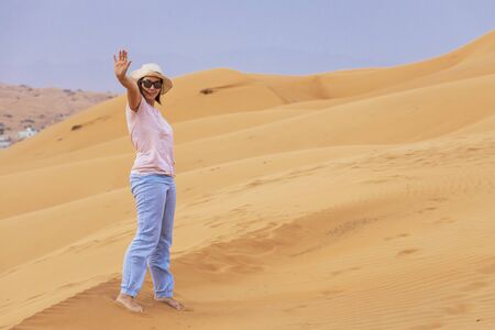 Trendy tourist on vacation. Modern woman on desert trip.の写真素材