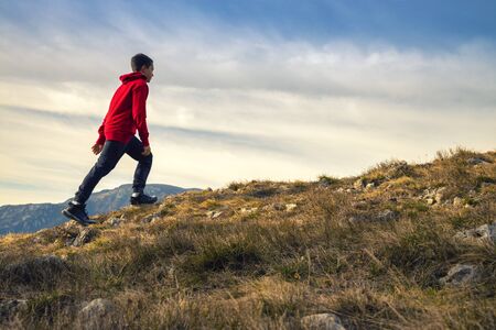 Experience freedom in the heart of nature. Active young man feeling free.の写真素材