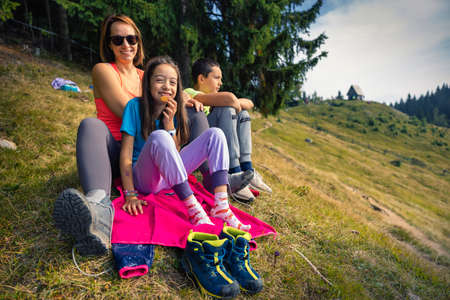Healthy way of living. Active family hiking in the park. Family gathering in the nature.の写真素材