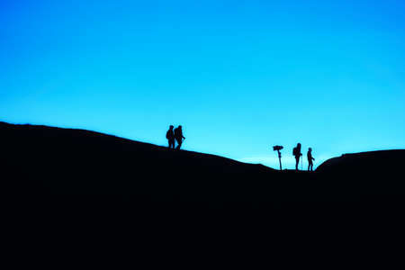 Active people enjoy freedom in nature. Family hiking in the national park high in the mountains.の写真素材