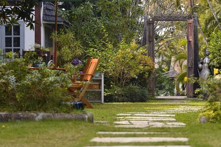 Outdoor garden beside the house increases the green area with a corner to relax.