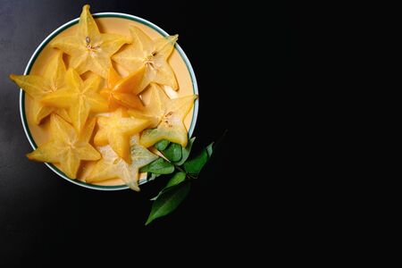 Star fruit or Averrhoa carambola isolated on black background. Exotic tropical fruit.