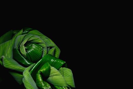Bouquet of roses flowers handmade from folded fragrant pandan leaves, isolated on black backgroundの写真素材
