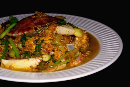 Stir fried crab with yellow curry powder, famous thai food.の写真素材