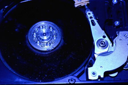Closeup hard disk detail isolated on blue background.の写真素材