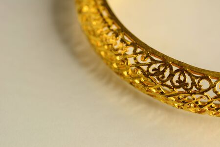 Gold color bracelet isolated on white background. Macro photography.の写真素材