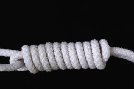 A white rope collection isolated on black background.の写真素材