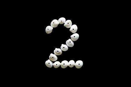 Sign number two from white cockles isolated on black background.の写真素材