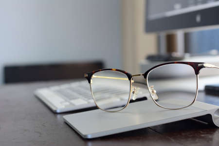 Eyeglasses on brown wooden table. Business concept.の写真素材
