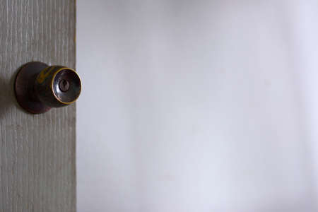Abstract brown knob and gray wooden door on natural white background.の写真素材