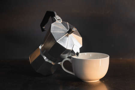 Moka pot on dark background. Coffee making concept.