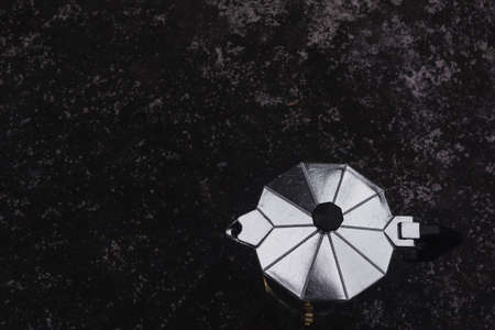 Moka pot on dark background. Coffee making concept.